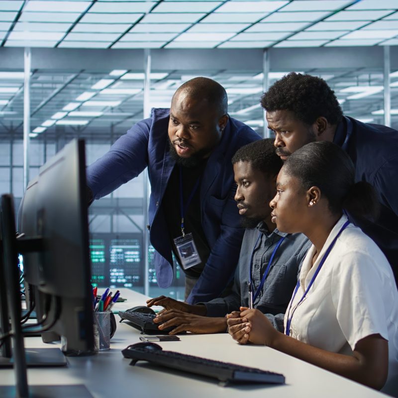 Coworkers in data center doing brainstorming, implementing AI predictive maintenance systems. Server hub colleagues discussing, using artificial intelligence to identify hardware failures, camera A